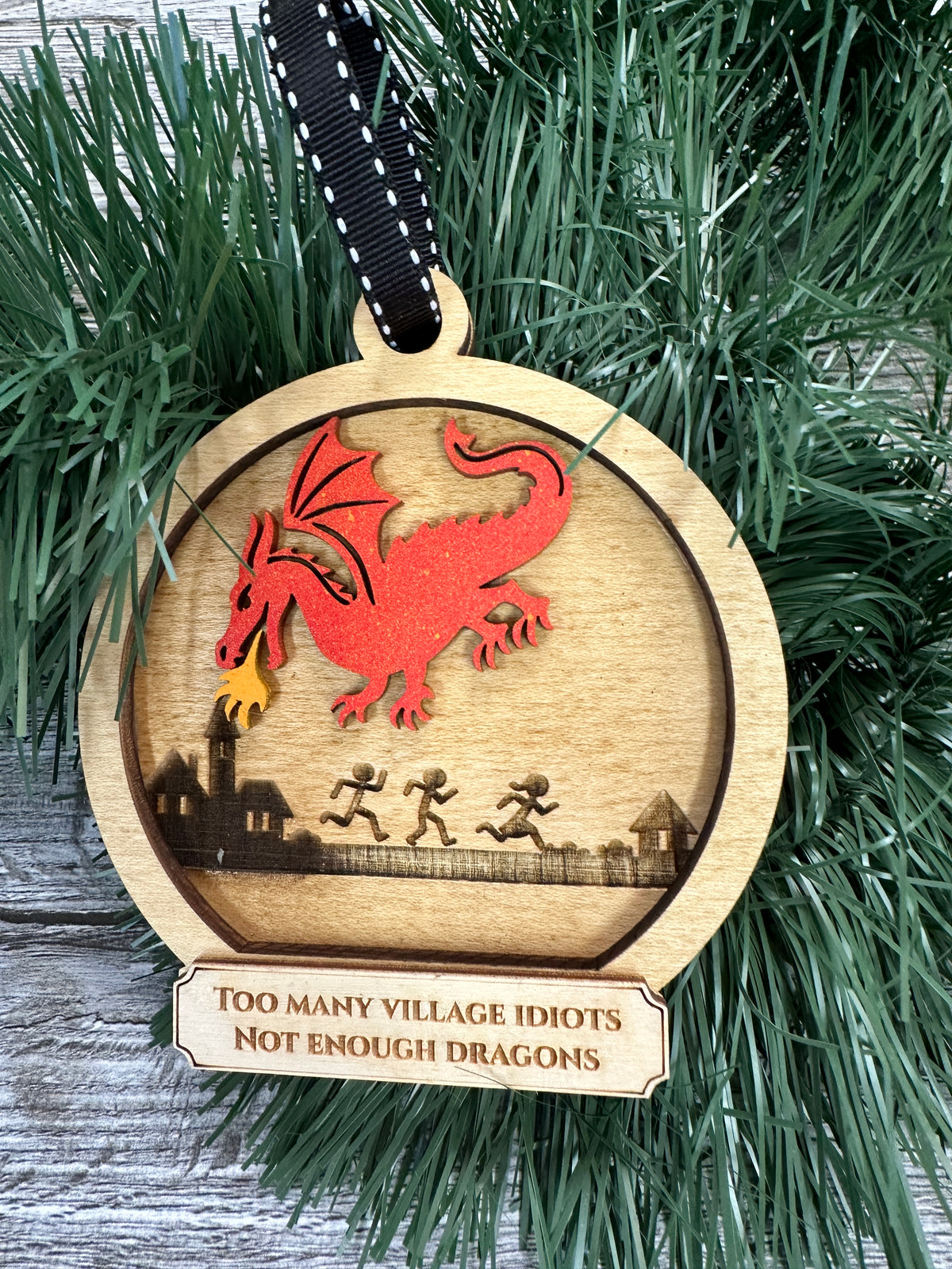 Dragon breathing fire at village idiots Ornament